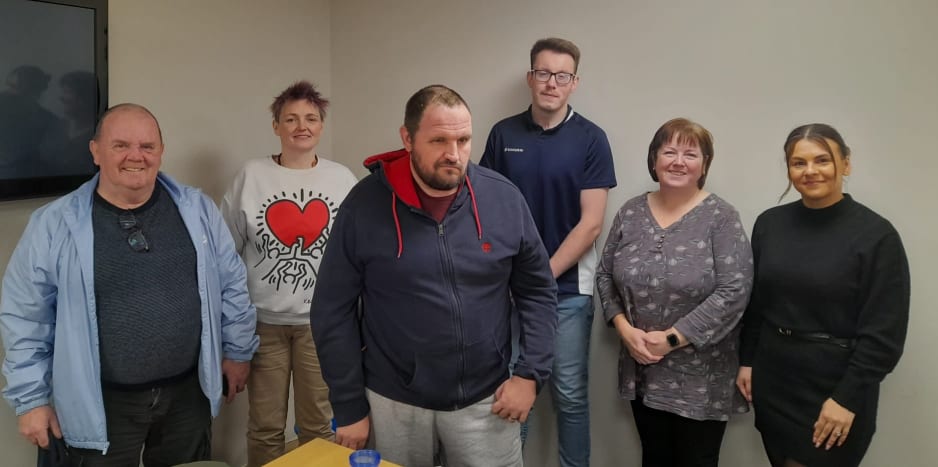 Image shows six people looking at camera and smiling after hypnotherapy session.