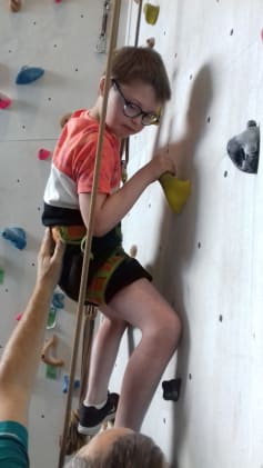 Image shows child on climbing wall.