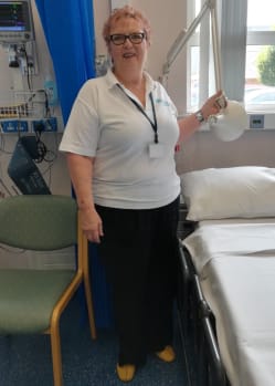 Kate Spence standing in hospital smiling.