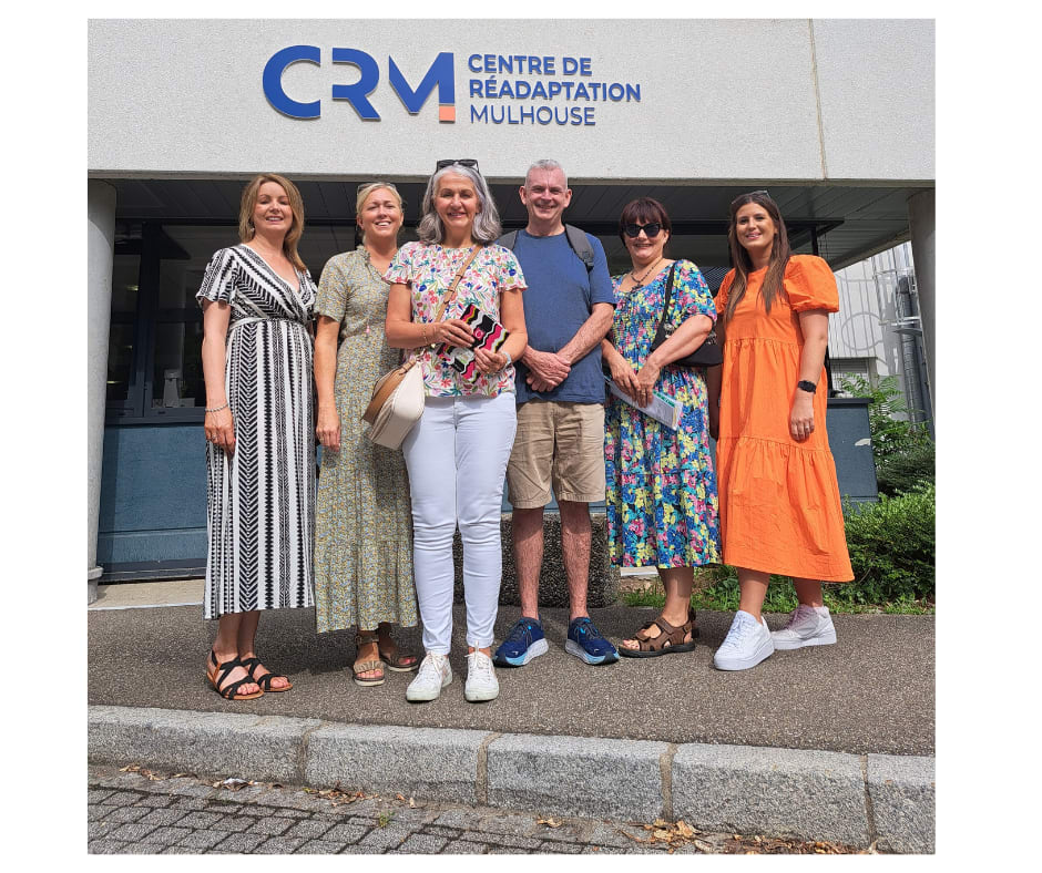 Image shows a group of Cedar representatives standing in front of the CRM building for the EPR Conference.